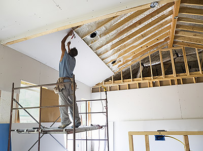 Putting up sheetrock in a home