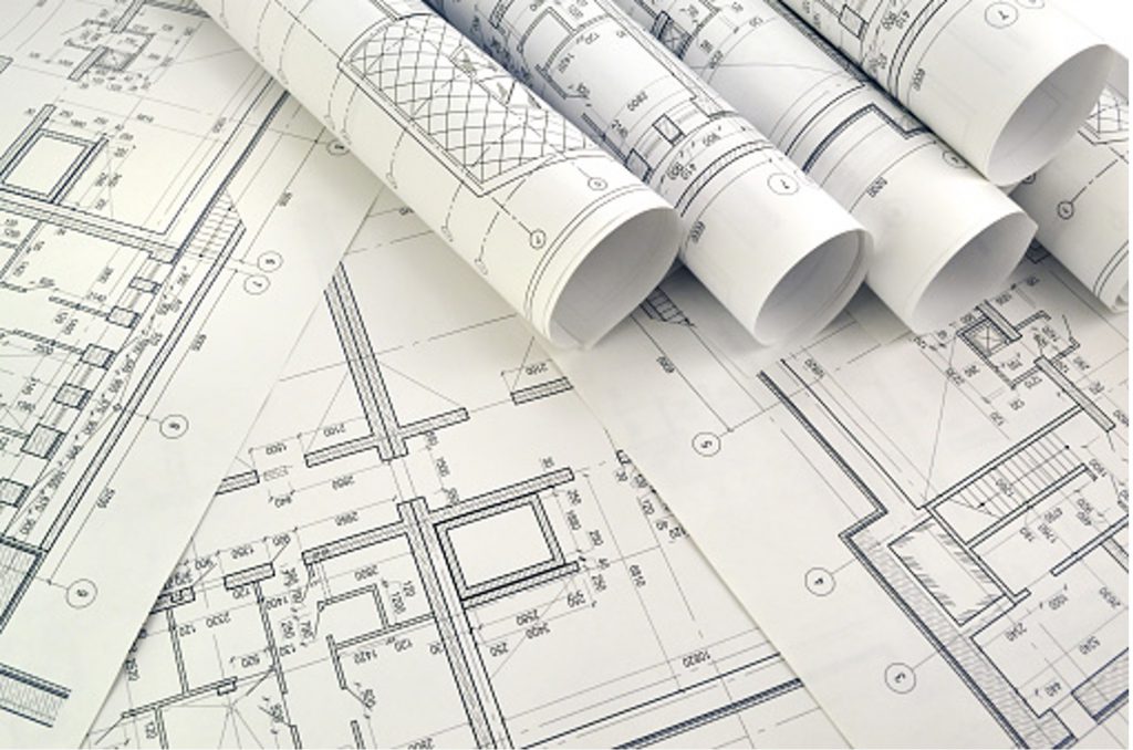blueprints on a table and rolled up