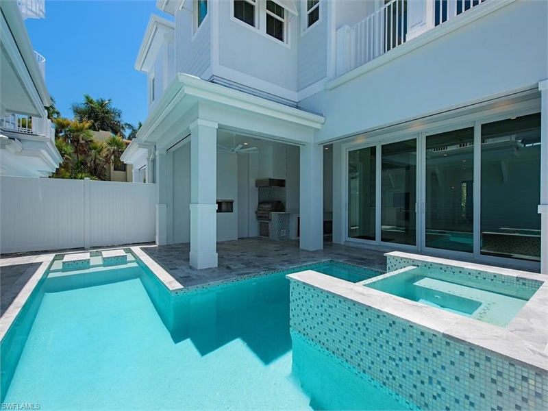 the pool area of a beach home