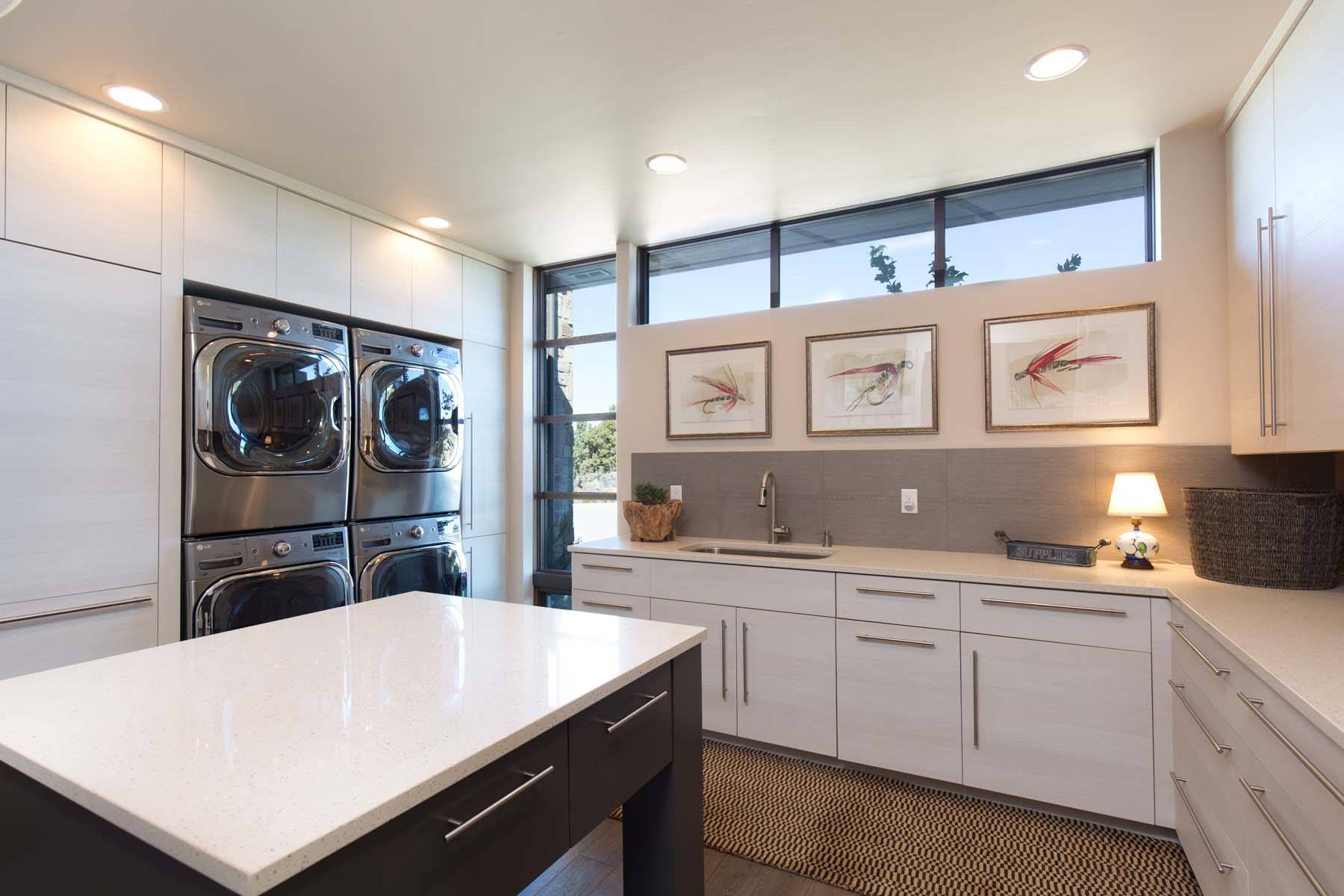 a huge, inviting laundry room with double appliances and a center island