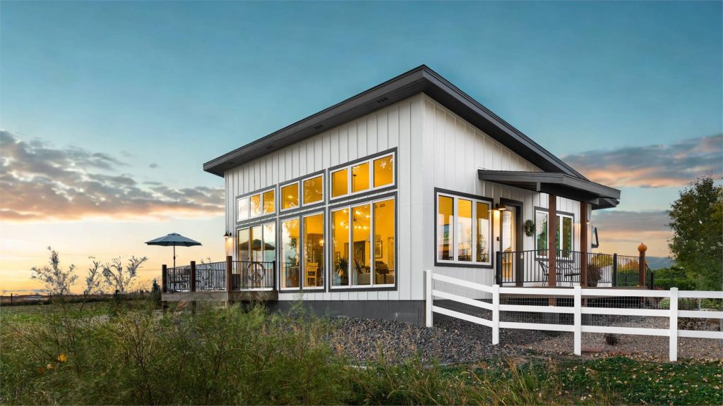 a barndo getaway with one bedroom, an office, and a wall of windows in the living space