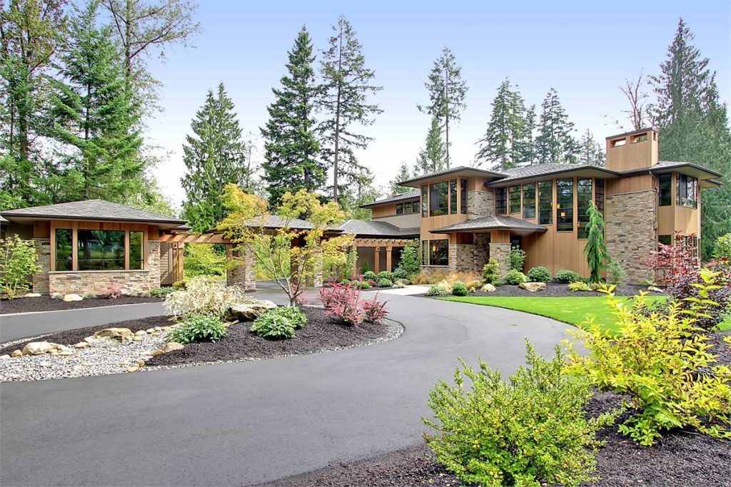 a Prairie-style luxury house plan with outdoor living spaces in back