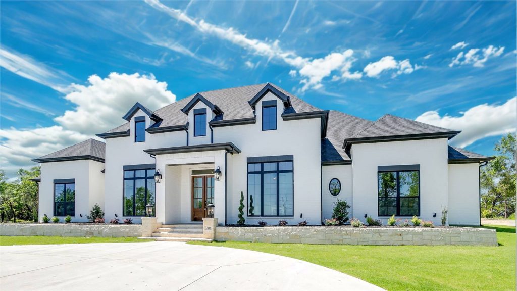 this grand European home boasts vaulted ceilings and an extended porch that build on the original design