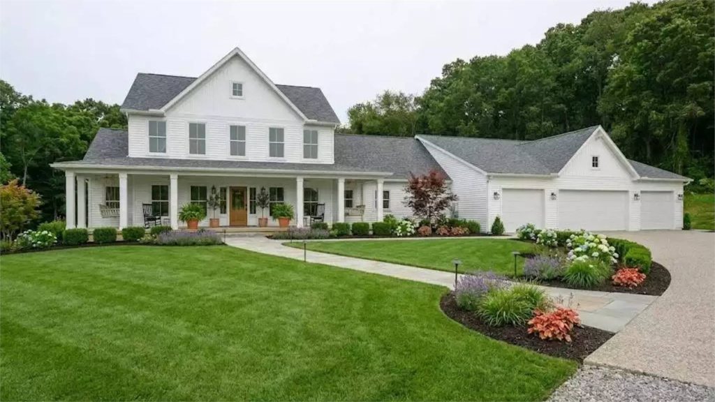 a sprawling farmhouse design with a huge garage and bedrooms split on two stories