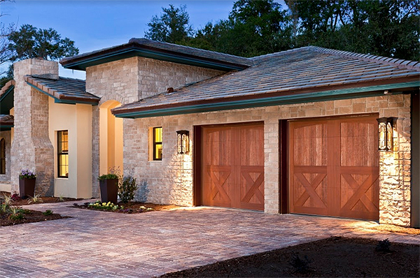 Lovely Faux Wood Carriage House Garage Doors on a Modern Mediterranean Home