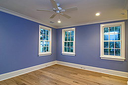 An Empty Room with Blue-Purple Walls, a White Ceiling, and White Trim with a Sheen That Shines