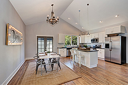 The Kitchen and Dining Space in an Open Home, with a Dramatic Cathedral Ceiling Overhead