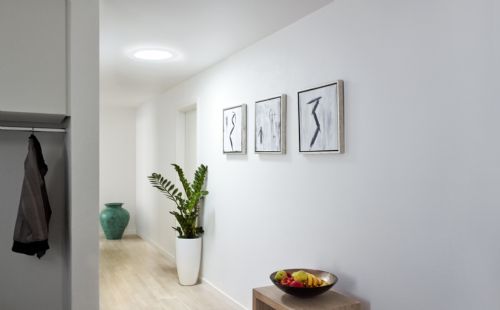 A Hallway with a Bright Sun Tunnel Skylight