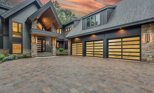 A Large Modern Home with Sleek Glass and Aluminum Garage Doors