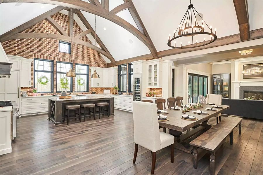 The Kitchen and Dining Area Open to the Great Room in a Luxe Home for a Sloping Lot