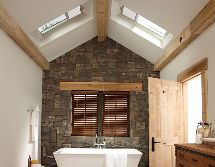 A Vaulted Bathroom with Skylights with Shades over the Tub