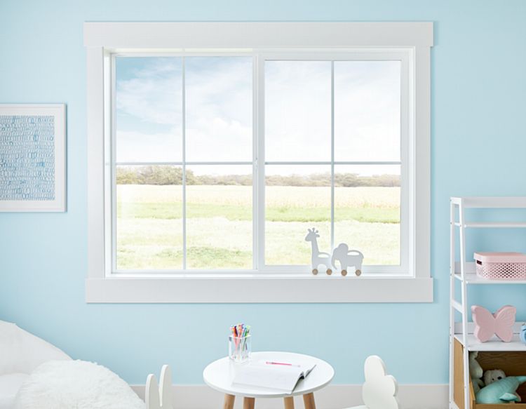 A Vinyl Sliding Window with Divided Lite Grilles Between Glass in a Children's Room