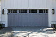 A Carriage House Door with Windows and a Painted Gray Surface