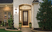 A Rich Wood-Look Entry for Traditional Homes, with Old World Wrought Iron in the Glass
