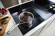 A Smooth Electric Cooktop with Downdraft Ventilation so You Don't Need a Hood
